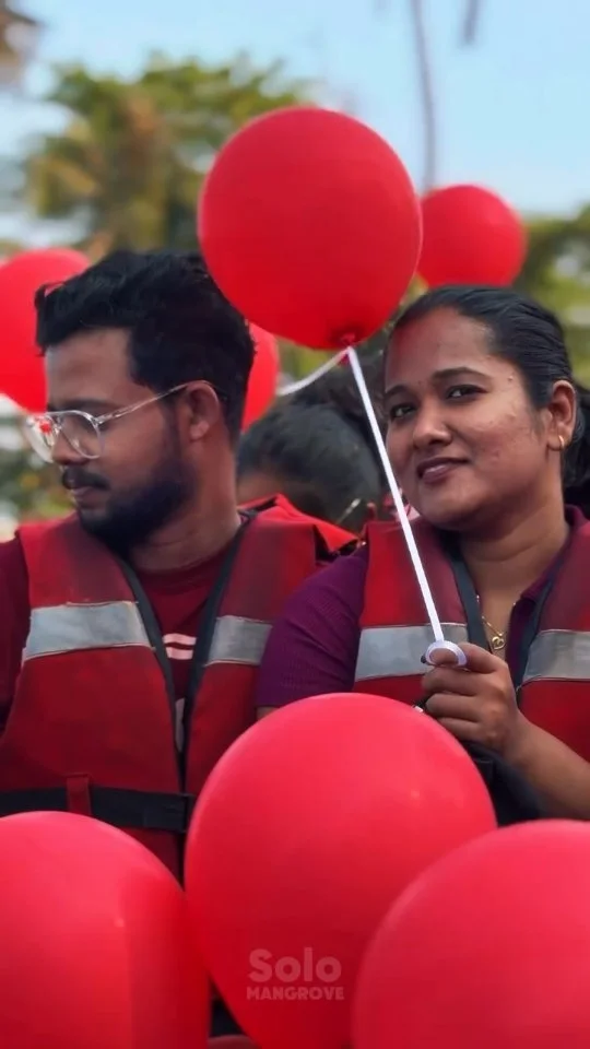 Couple kayaking at sunset on Kadamakkudy backwaters